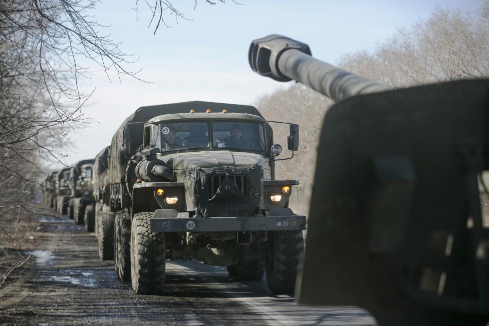 Trucks of the separatist self-proclaimed Donetsk People's Republic army towing mobile artillery cannons, are seen as they pull back from Donetsk